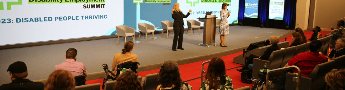 New Website Page Banner Images 1100×290 (1) Auditorium stage with speaker and ASL interpreter the first couple rows of an engaged audience are visible.