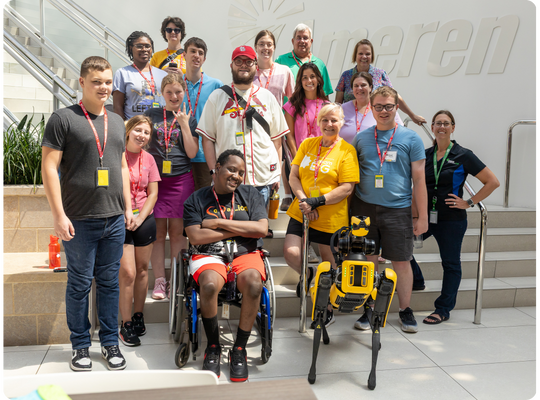 2025-camp-report-group-photo-week-4 Group photo of students and staff at Ameren, including a robot dog.