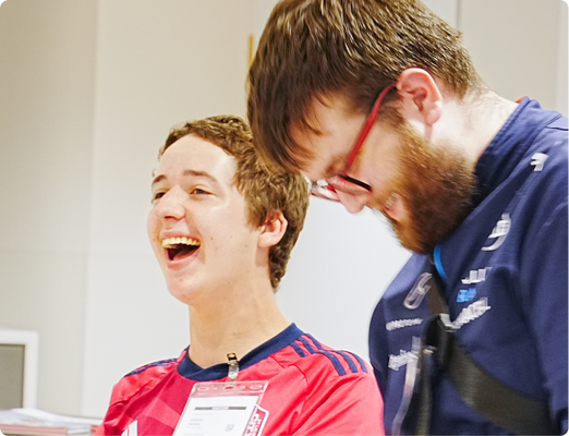 2025-camp-report-laughing Students laughing together.