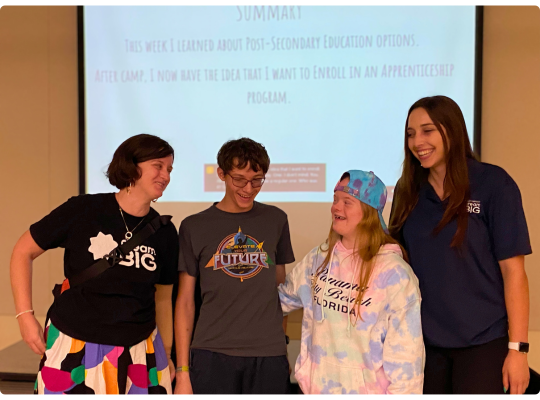 Dream Big staff and students laugh together.